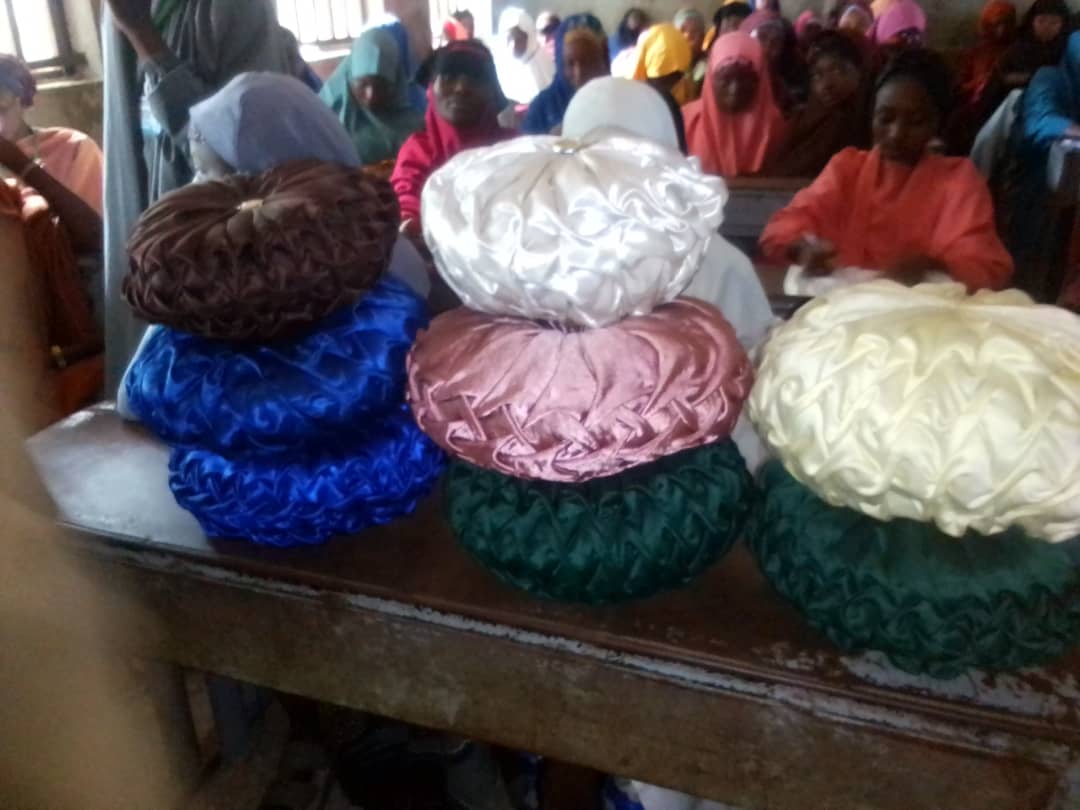 Colorful satin bonnets made by skills training participants